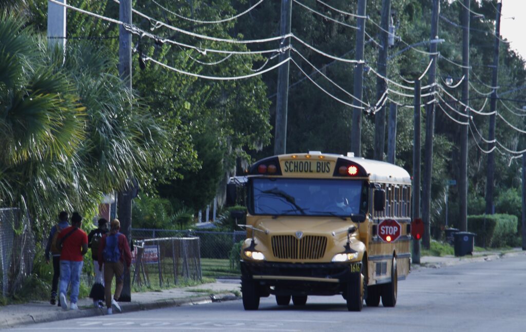 A bus stops on South Street in Daytona Beach on Monday morning to pick up high school students.