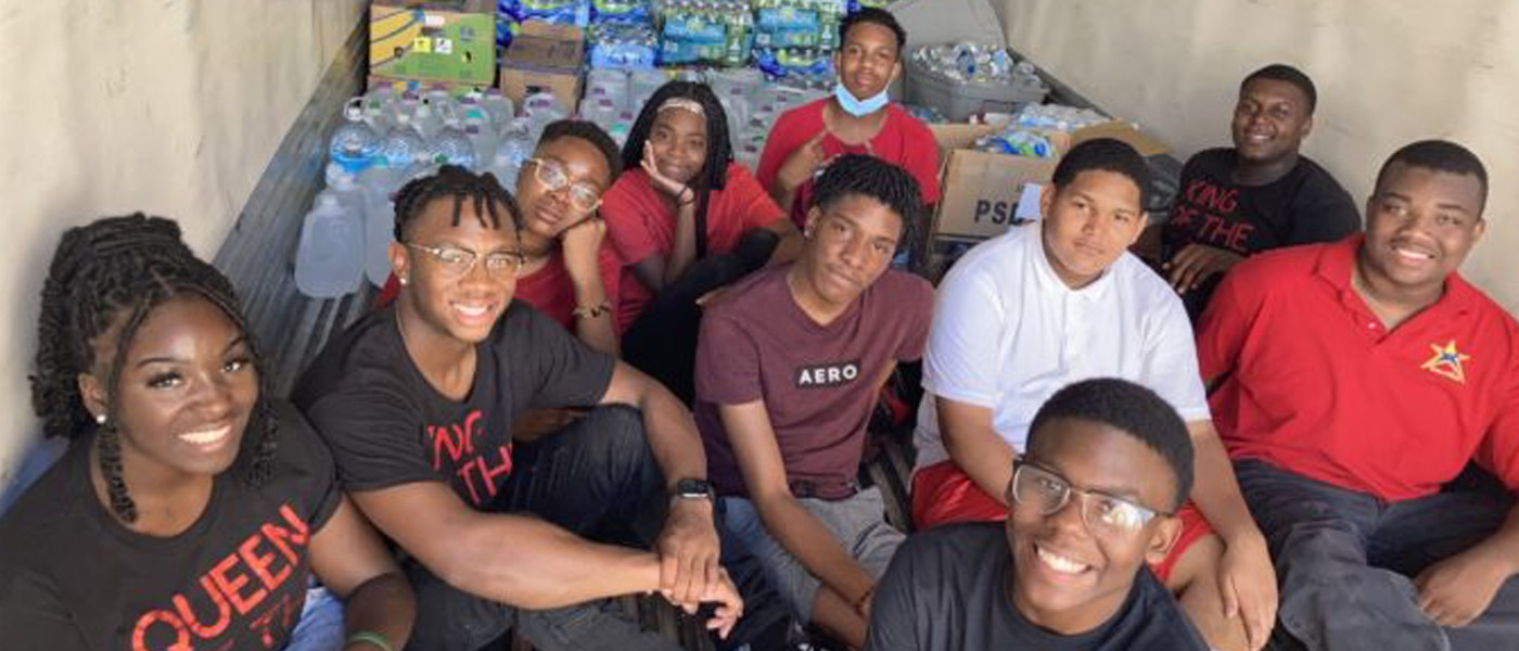 Shown are the teens with the surplus of water donations