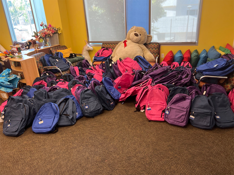 The 150 backpacks were placed in the Hope Street Margolis Family Center library, awaiting distribution to the students. (source: assistanceleaguela.org).