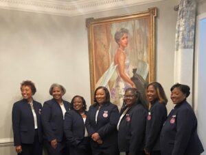 Jack and Jill of America’s 2022-2024 National Executive Board Members stand near a portrait of Founder Marion Stubbs Thomas. Pictured from left to right are the following: National Corresponding Secretary Nichelle Nicholes Levy, National Program Director Marvis Donalson; National Vice President Sativa Leach-Bowen; National President Kornisha McGill Brown; National Treasurer Michele Henry-McGee; National Recording Secretary Ily Houston; and National Editor Amanda McWilliams. (Photo Courtesy of Jack and Jill of America)