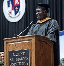 Tampa Bay Buccaneers head coach Todd Bowles speaks to the graduates and crowd at the 215th commencement exercise for of Mount St Mary's University, Saturday, May 13, 2023, in Emmitsburg, Md.. Bowles finished his degree in September of 2022 but wanted to walk the stage on Saturday. (Ric Dugan/The Frederick News-Post via AP)