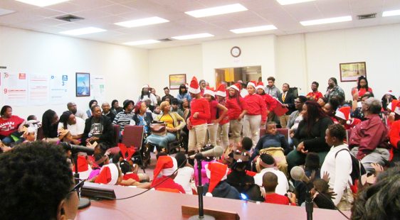 Students from after-school  enrichment project present Christmas program at school board gathering
