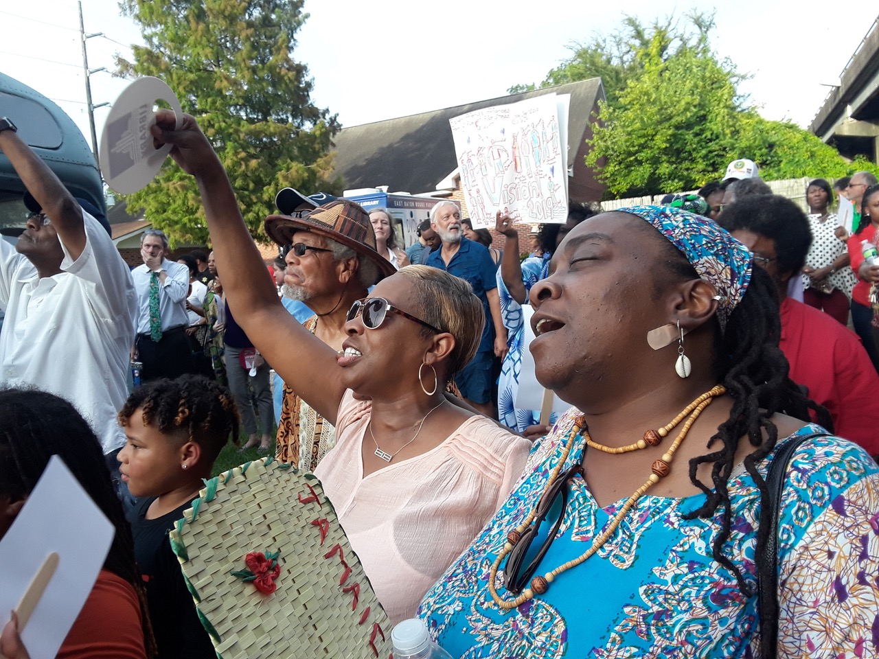 Erica Williams Mitchell, Phyllis, and Owusu Bandele, Ph.D. sing along with the crowd gathering at Sadie Roberts-Joseph vigil at the Baton Rouge African-American History Museum. Photo by Antione GHOST Mitchell @the_art_alchemist