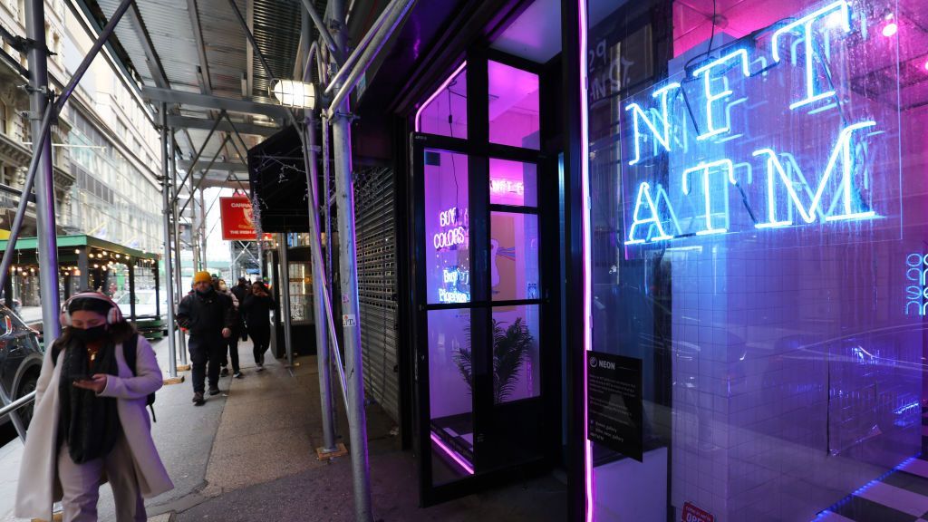 According to indie work website Fiverr, 64 percent of U.S.-based freelancers have profited from selling NFT-related services. Pictured, people walk past an NFT vending machine location on Feb. 24, 2022, in New York City. The world's first NFT vending machine, from the company Neon, accepts credit and debit cards and dispenses a box with a unique code inside for your chosen NFT. (Michael M. Santiago/Getty Images)