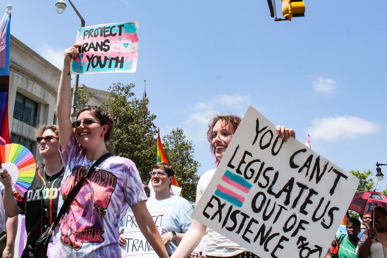 Protesters carry signs in support of transgender people in Montgomery, Alabama