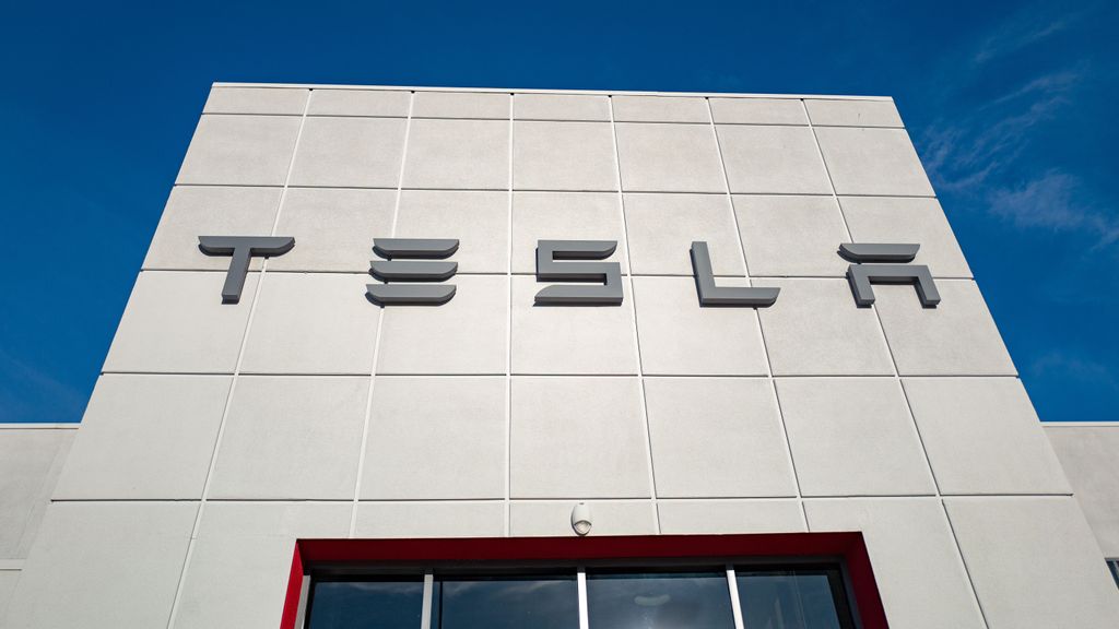 Low-angle view of the facade of Tesla Motors dealership with logo and sign in Pleasanton, California, July 23, 2018. (Photo by Smith Collection/Gado/Getty Images)