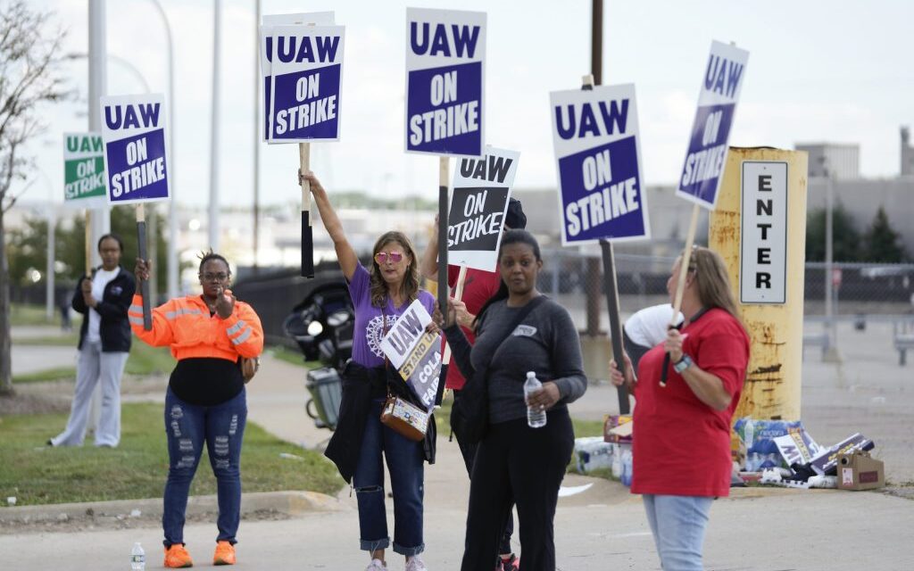 Workers strike at all 3 Detroit automakers, a new tactic to squeeze companies for better pay