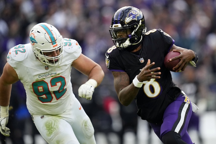 Lamar Jackson’s perfect passer rating helps Ravens rout Dolphins 56-19 to clinch top seed in AFC