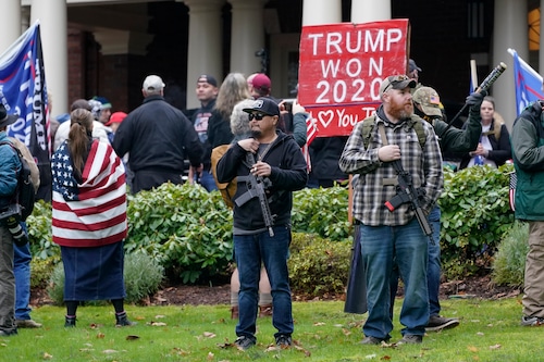 Protesters stand armed with guns in front of the Governor's Mansion in Olympia, Washington Jan. 6, 2021, during a protest supporting President Donald Trump and against the counting of electoral votes in Washington, D.C., affirming President-elect Joe Biden's victory.  (AP Photo/Ted S. Warren, File)