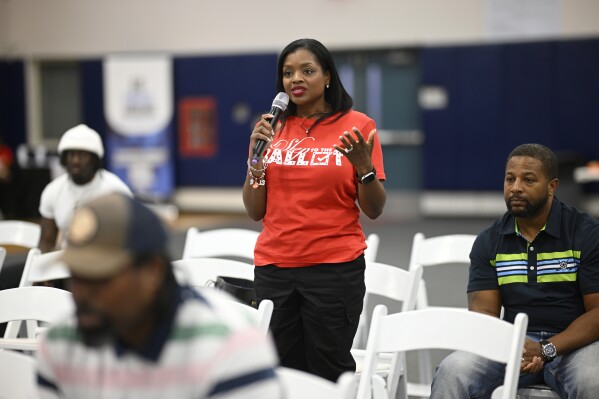 Derby Johnson, of Ormond Beach, Fla., asks a question of panelists during the Voters Education 2024 Community Forum, addressing the Florida Legislature's voter suppression tactics, Thursday, May 16, 2024, in Daytona Beach, Fla. Laws passed in several Republican-controlled states are making it challenging for advocates to adapt as they try to register and educate potential voters with just months to go before the presidential election. (AP Photo/Phelan M. Ebenhack)