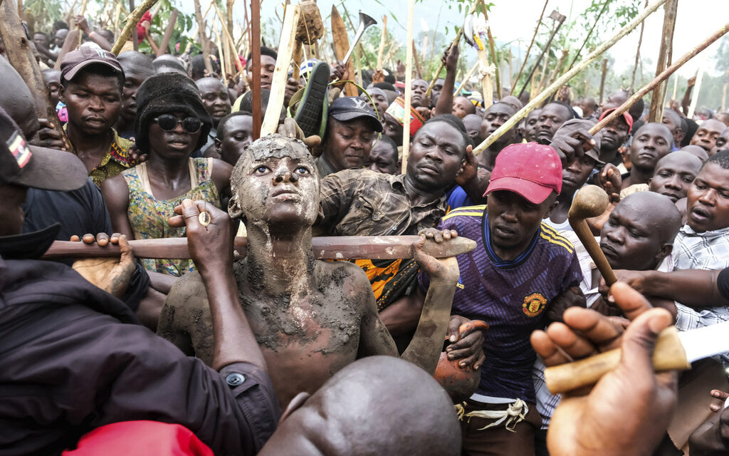 A mass circumcision is marketed to tourists in a remote area of Uganda. Some are angrily objecting