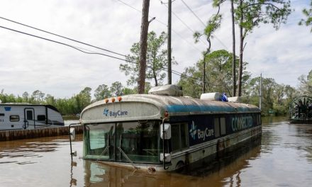 Residents slog through flooded streets, clear debris after Hurricane Milton tore through Florida