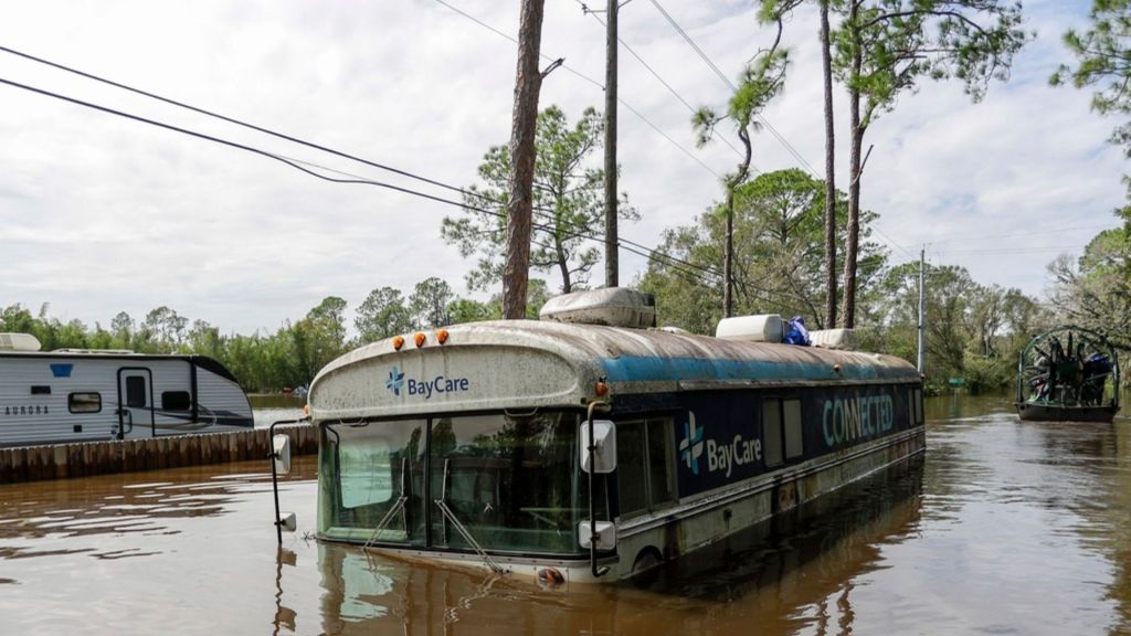 Residents slog through flooded streets, clear debris after Hurricane Milton tore through Florida