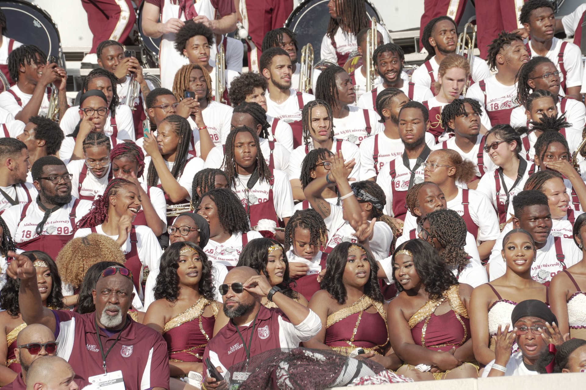 Aliya Khanthavong in an informal large group photo of the MMW sitting in the stands at Louis Crews Stadium