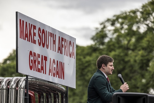 About a week after U.S. President Donald Trump signed an executive order declaring that the United States “shall promote the resettlement of Afrikaner refugees escaping government-sponsored race-based discrimination, South African internet personality and Afrikaner commentator Willem Petzer addressed a group of pro-Trump white South Africans gathered in front of the U.S. Embassy in Pretoria, South Africa, in this Feb. 15, 2025, file photo.
